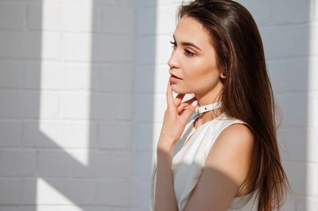 Woman in White Top Posing for Picture